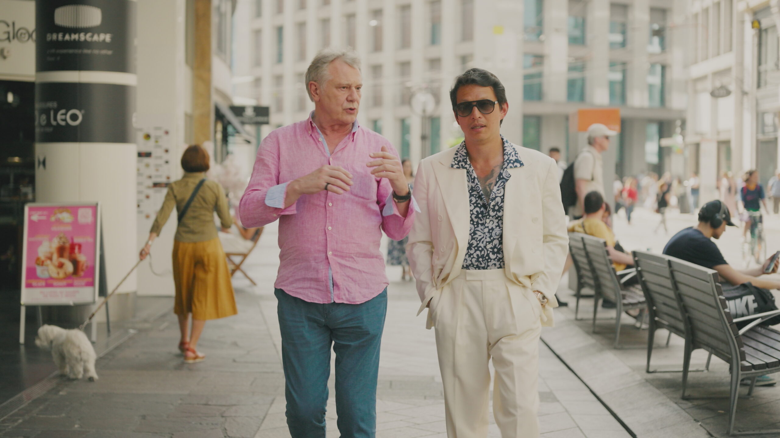 Wei Koh and François-Paul Journe walking and talking on a Geneva street while filming Man of the Hour